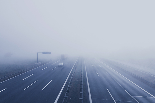 cars on dual carriageway in fog