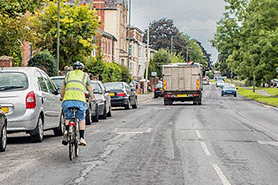 cyclist and lorry on busy road ahead