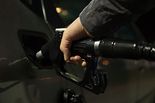 man holding a fuel nozzle
