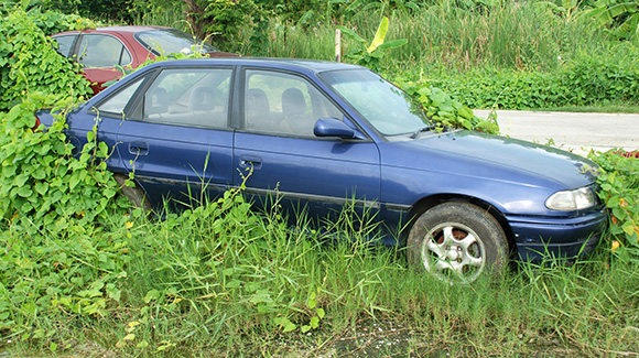 old blue car parked on grass
