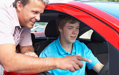 teenage boy learning to drive with instructor