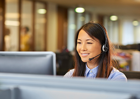 young happy lady working in call centre on headset