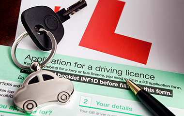 provisional driving licence application form with car keys and pen