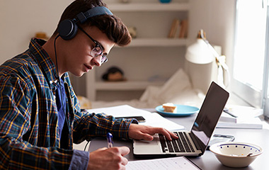 teenage boy revising in his bedroom