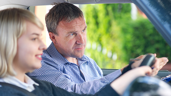 young lady having driving lesson with instructor