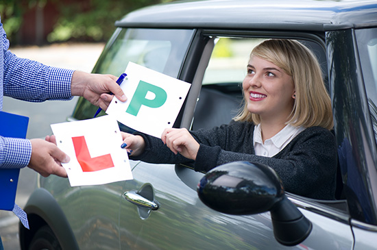 Young newly qualified driver with their car