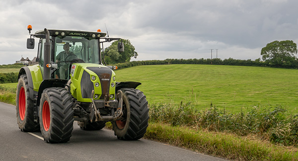 green tractor on country road