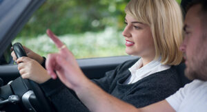 happy teenage girl on driving lesson