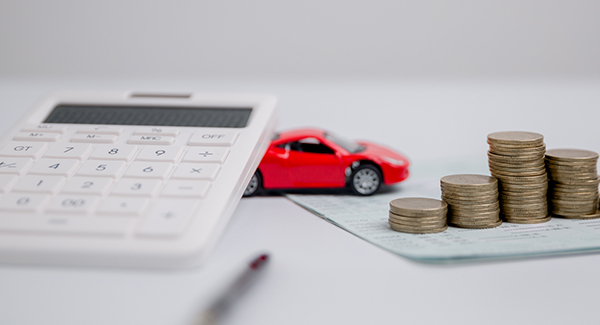 Toy car with coins stacked and calculator