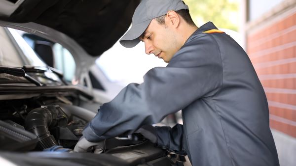 Driver carrying out basic car maintenance